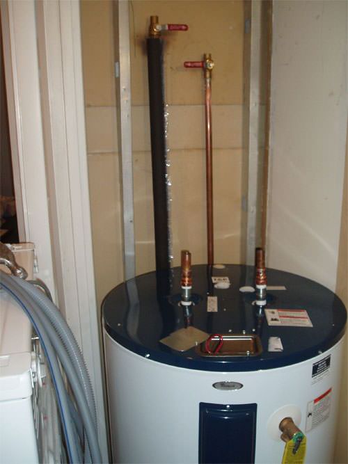 A water heater system (tank style) installed in a [territory] home